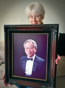 Carol Min holds photo of Min Byung-Soo after LA riots