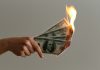 401K Identity Theft Scam Drains Retirement Accounts burned 100 US dollar banknotes