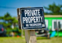 Cyber Alert: New Zoom Link Phishing Scam Targets Real Estate Agents a private property sign posted on a wooden post