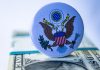 Social Security Overpayment Recovery Sparks Senior Fears A close up of a button on a dollar bill