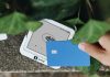 California Surveillance Pricing Ban A hand holding a credit card next to a cell phone