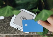 California Surveillance Pricing Ban A hand holding a credit card next to a cell phone