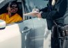 LAPD DUI checkpoint — Major Crackdown in Koreatown & LA A police officer writes a ticket for a driver in a car during a roadside stop.